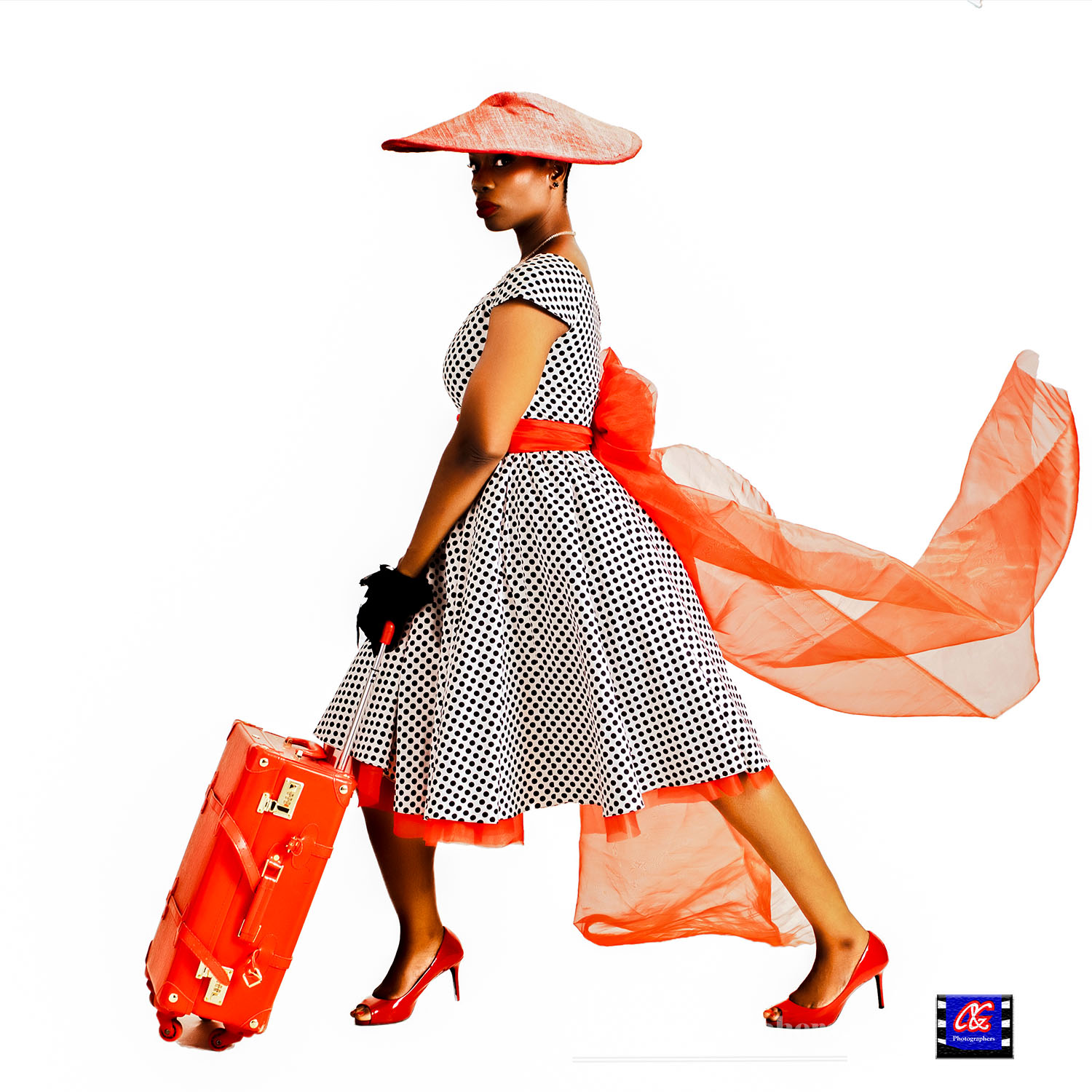 A Fashion photography portrait of a female model walking with a travelling briefcase