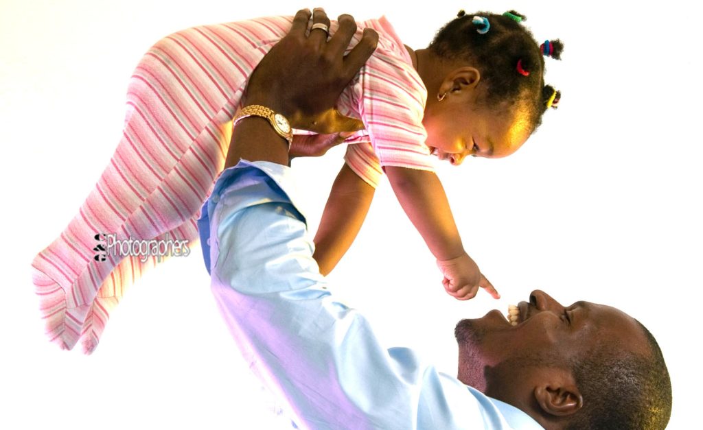 Father and baby daughter in a playing advertising photography shoot