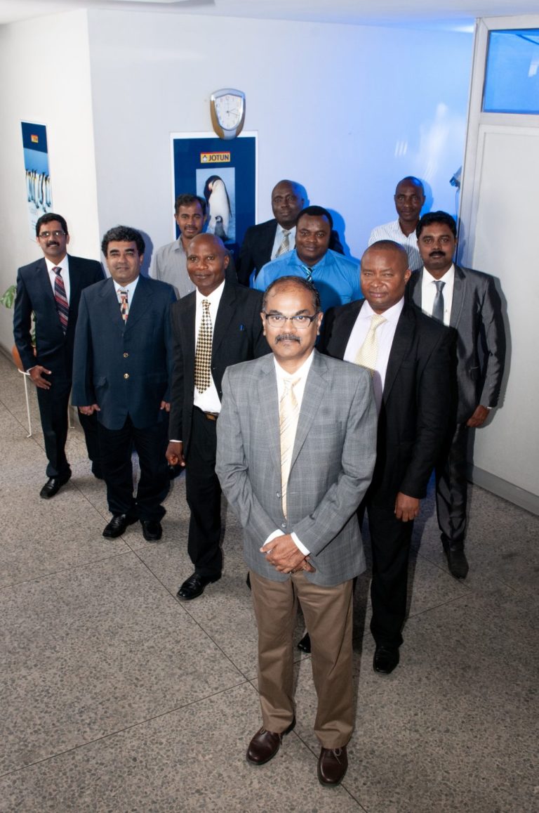 Group of corporate directors in formal business attire posing for a professional group portrait