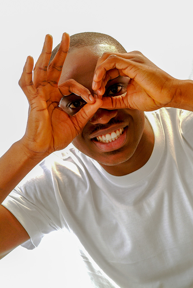 Creative portrait advertising photography of a man making a funny hand gesture in Lagos Nigeria
