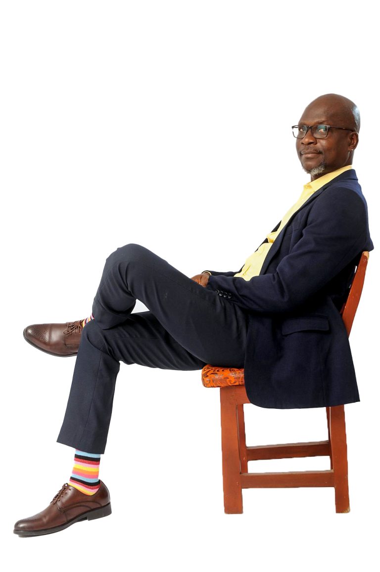 Seated executive director in a suit posing for a corporate portrait on a clean background