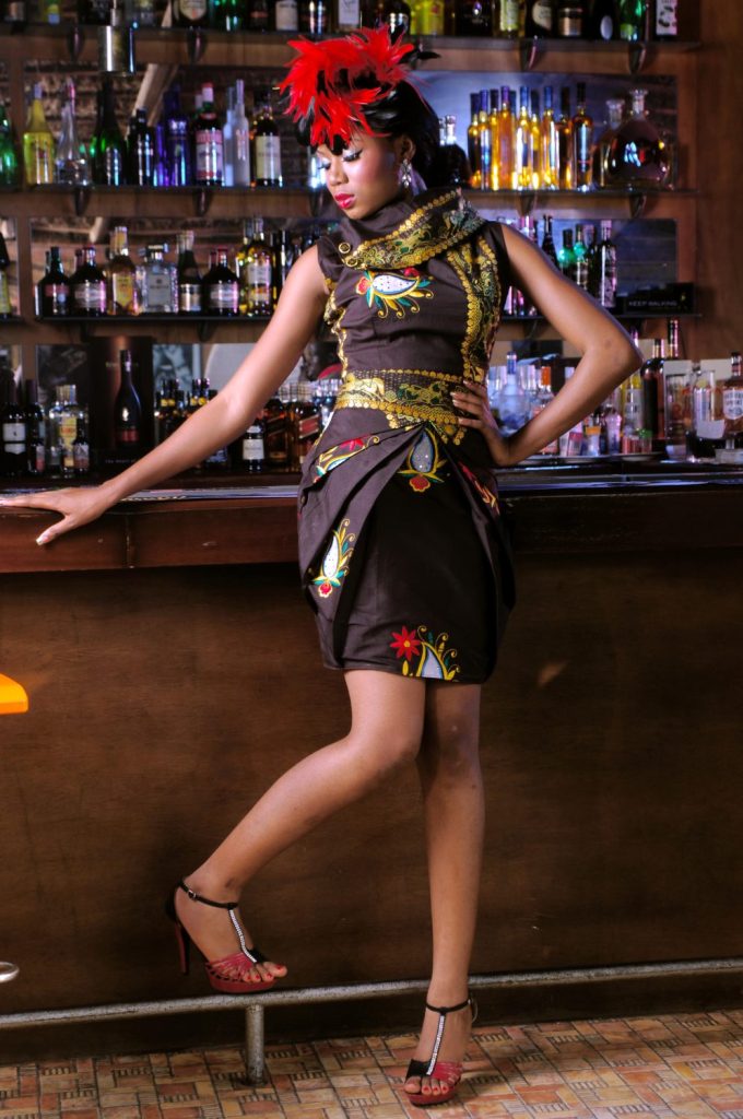 Fashion model posing in a stylish outfit inside a bar setting during a creative editorial photoshoot