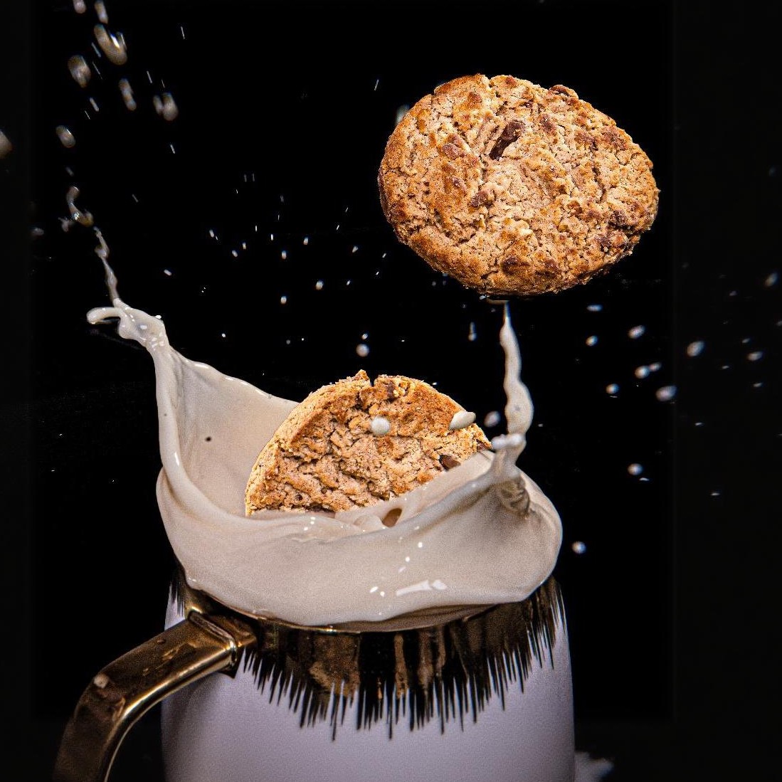 Cookie and milk splash captured in a dynamic moment for food and beverage product advertising photography in Lagos