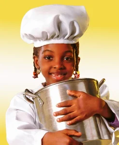 Advertising portrait of a child chef holding a cooking pot in Lagos Nigeria