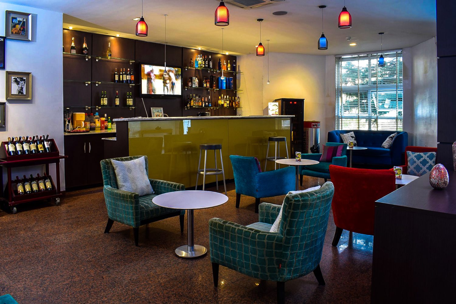 Contemporary hotel bar and lounge space featuring stylish seating, ambient lighting, and a relaxed social atmosphere.