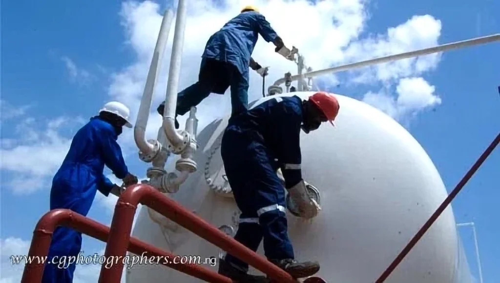 industrial workers performing maintenance on oil and gas equipment facility