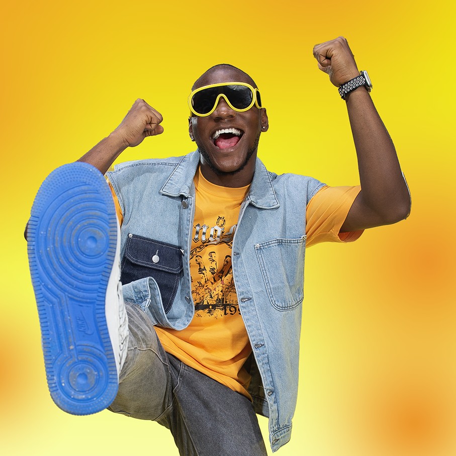 Lifestyle advertising portrait photography of a man celebrating on a yellow background in Lagos Nigeria