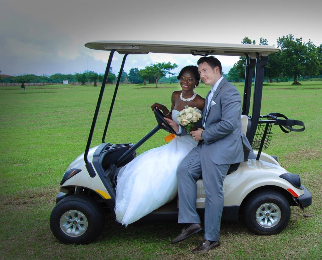 Bride and groom on golf cart outdoor wedding photography Asaba Delta State Nigeria
