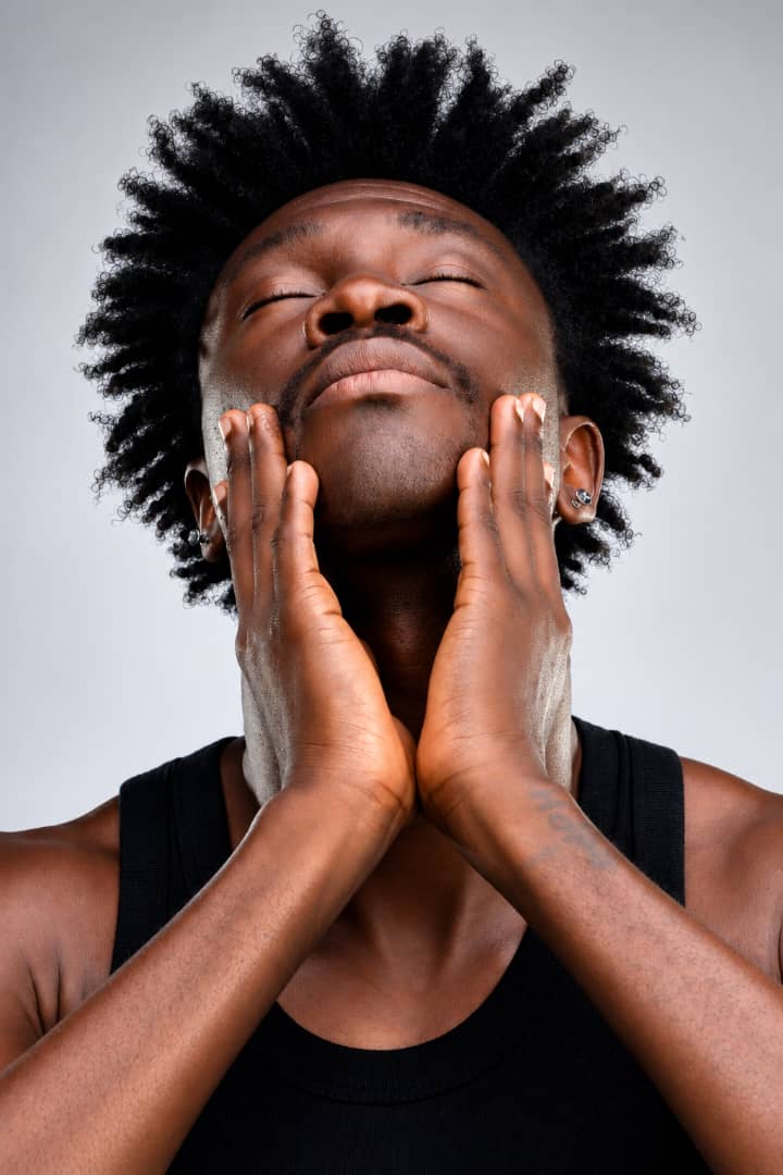Man touching his face in a creative commercial portrait