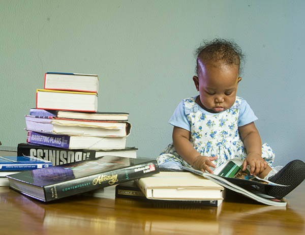 Young child exploring books as part of an early learning experience