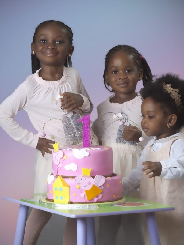 Birthday photograph of siblings celebrating with their sister the celebrant at their home. by C&G Photographers